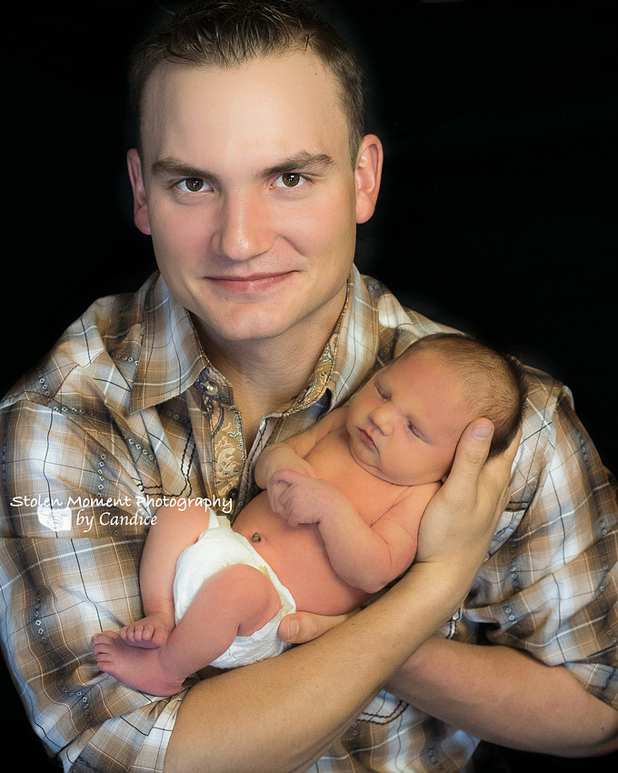 Dad holding his newborn son