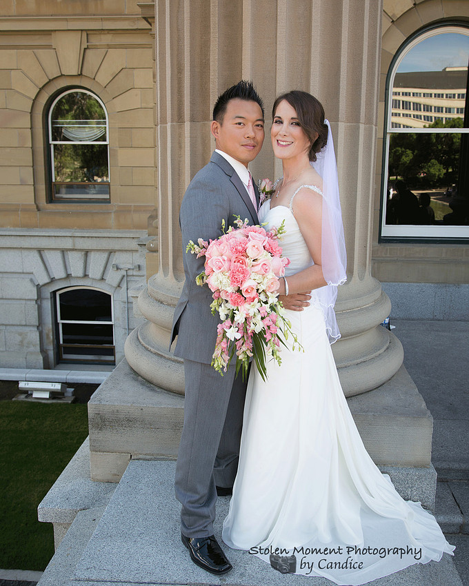 Bride and Groom on ledge at the Legislature Grounds in Edmonton