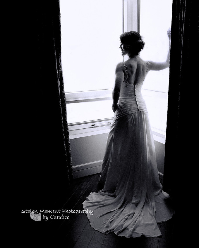 Bride in silhouette by window