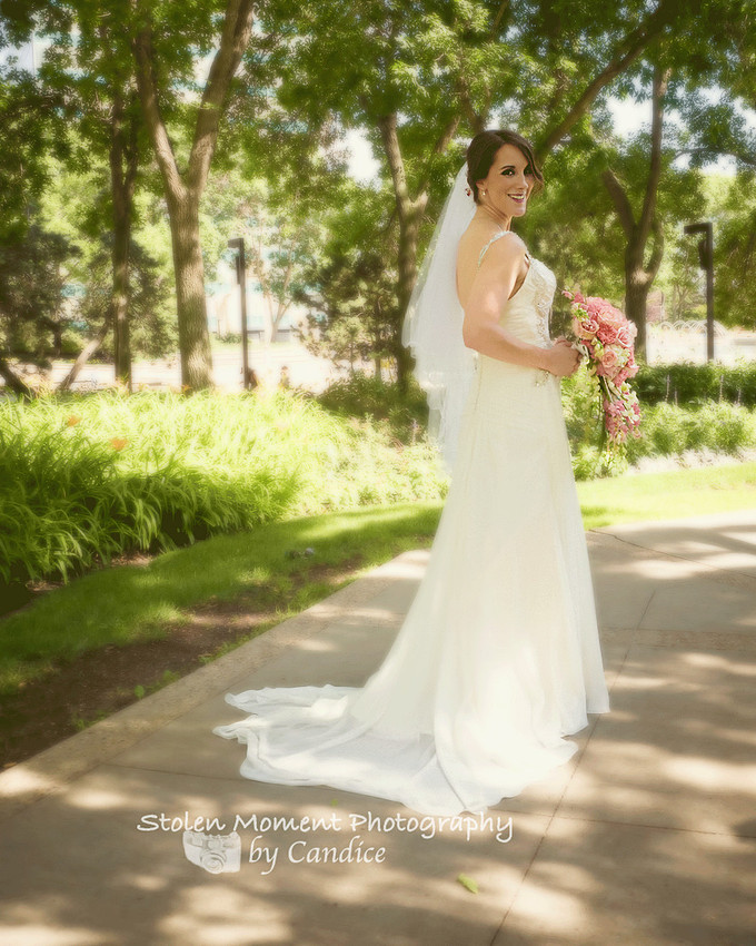 bride standing among the trees