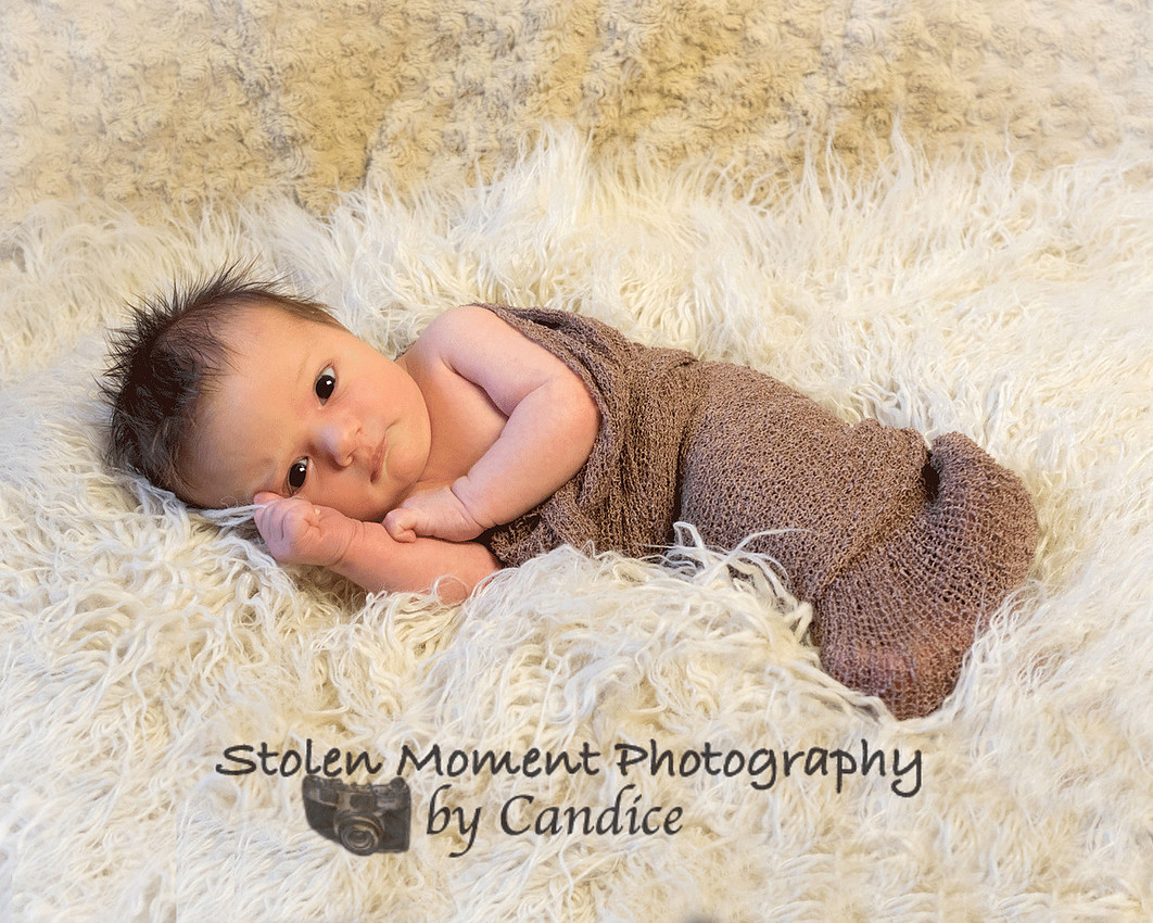 newborn baby looking at camera