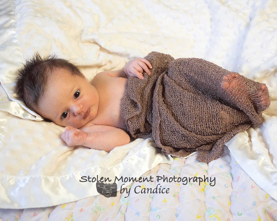 newborn girl looking at camera