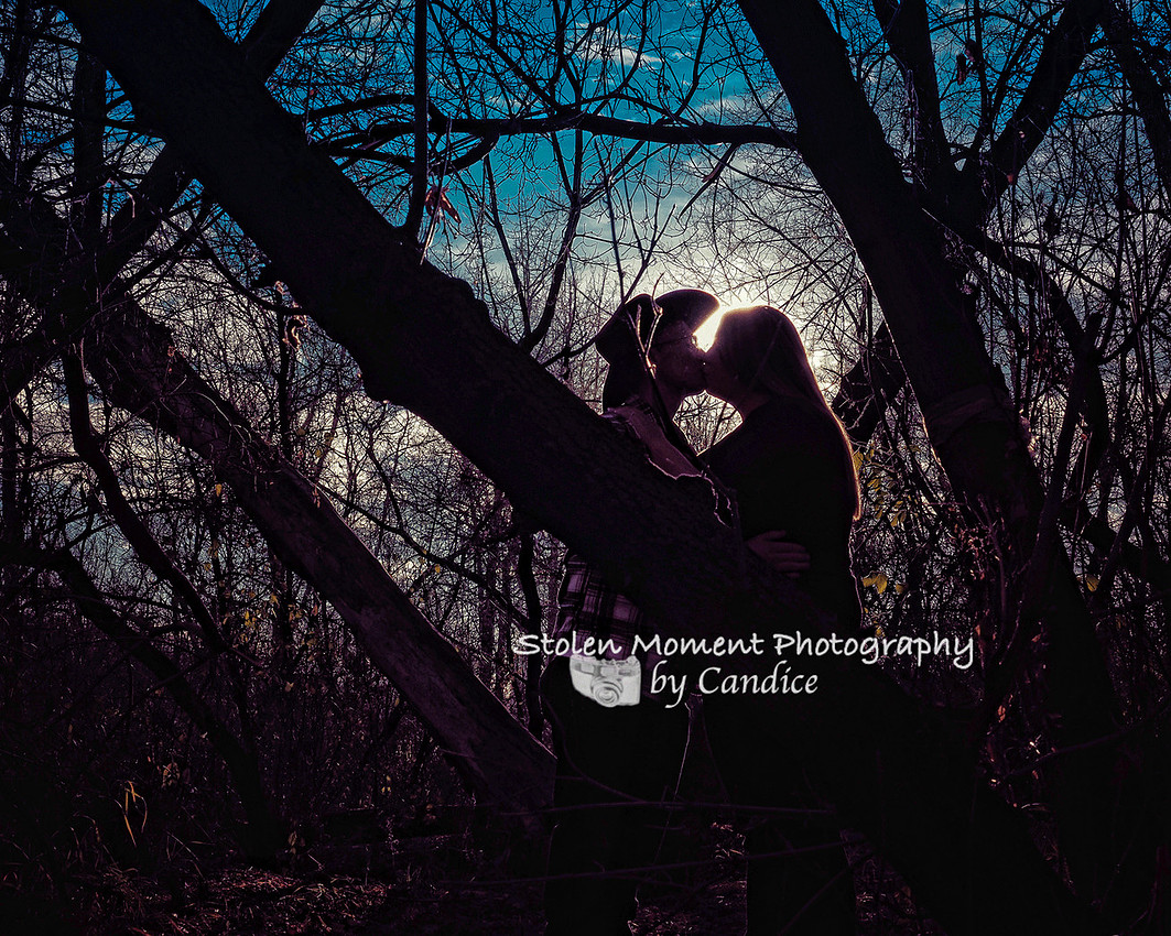 a silhouette shot of an engaged couple