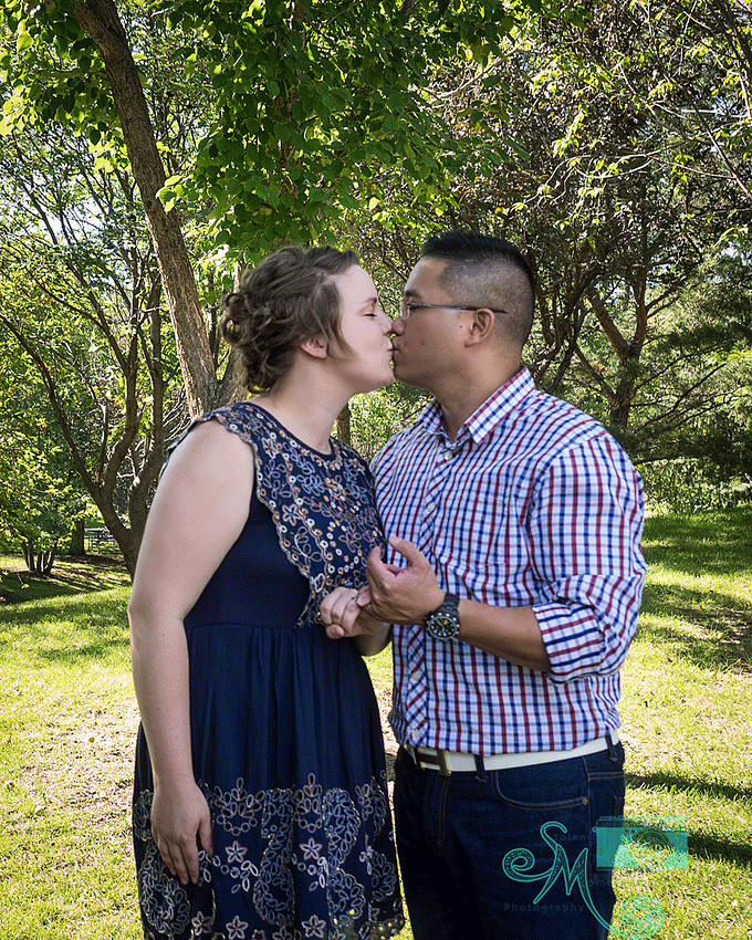 couple kissing while doing "pinky swear"