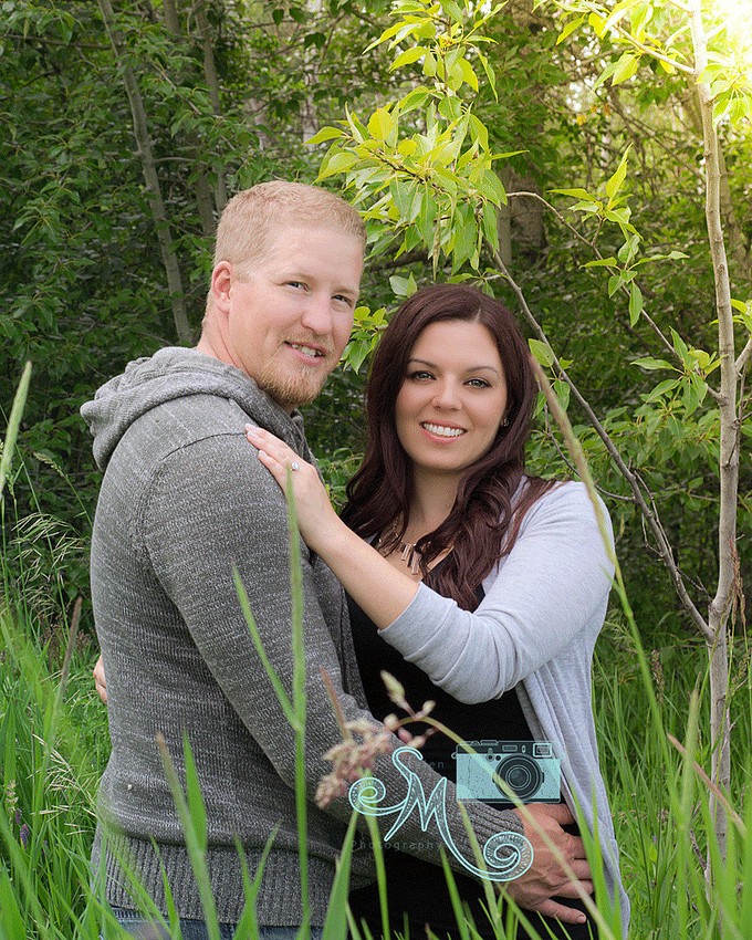 couple standing amongst the tall grass