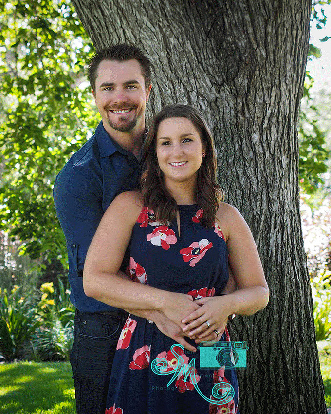 couple pose in front of tree