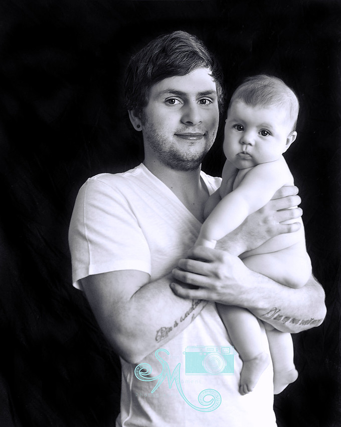 Dad holding his 3 month old daughter