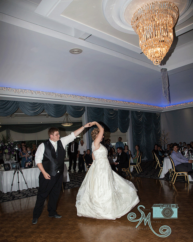 groom twirling bride during first dance