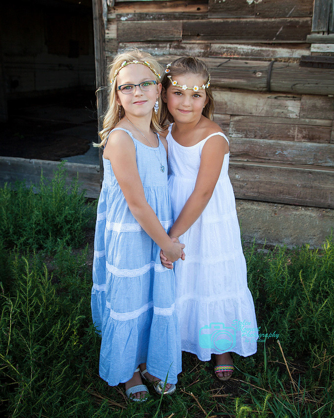 two sisters holding hands in sundresses
