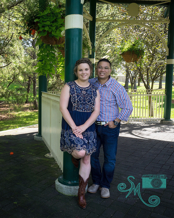 couple posing under gazebo