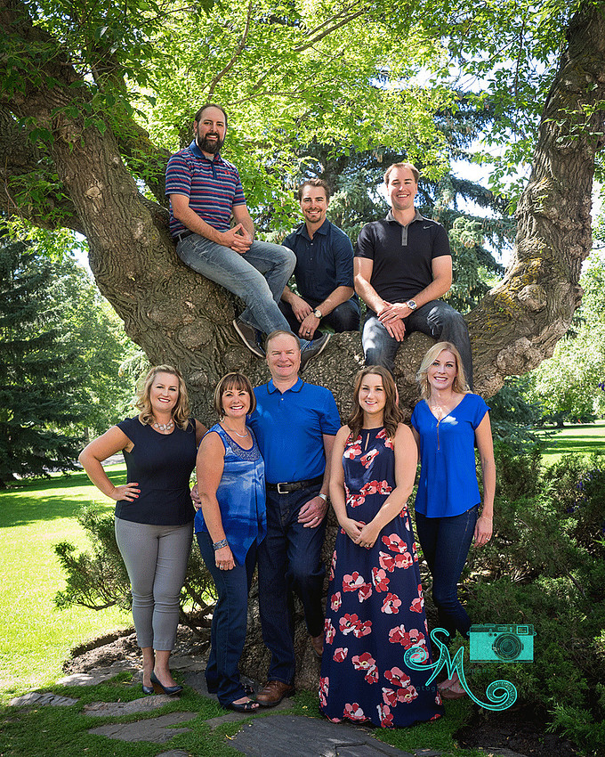 Family in front of and in tree