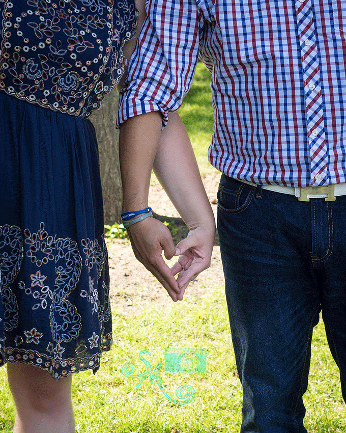 couple's hands forming a heart 