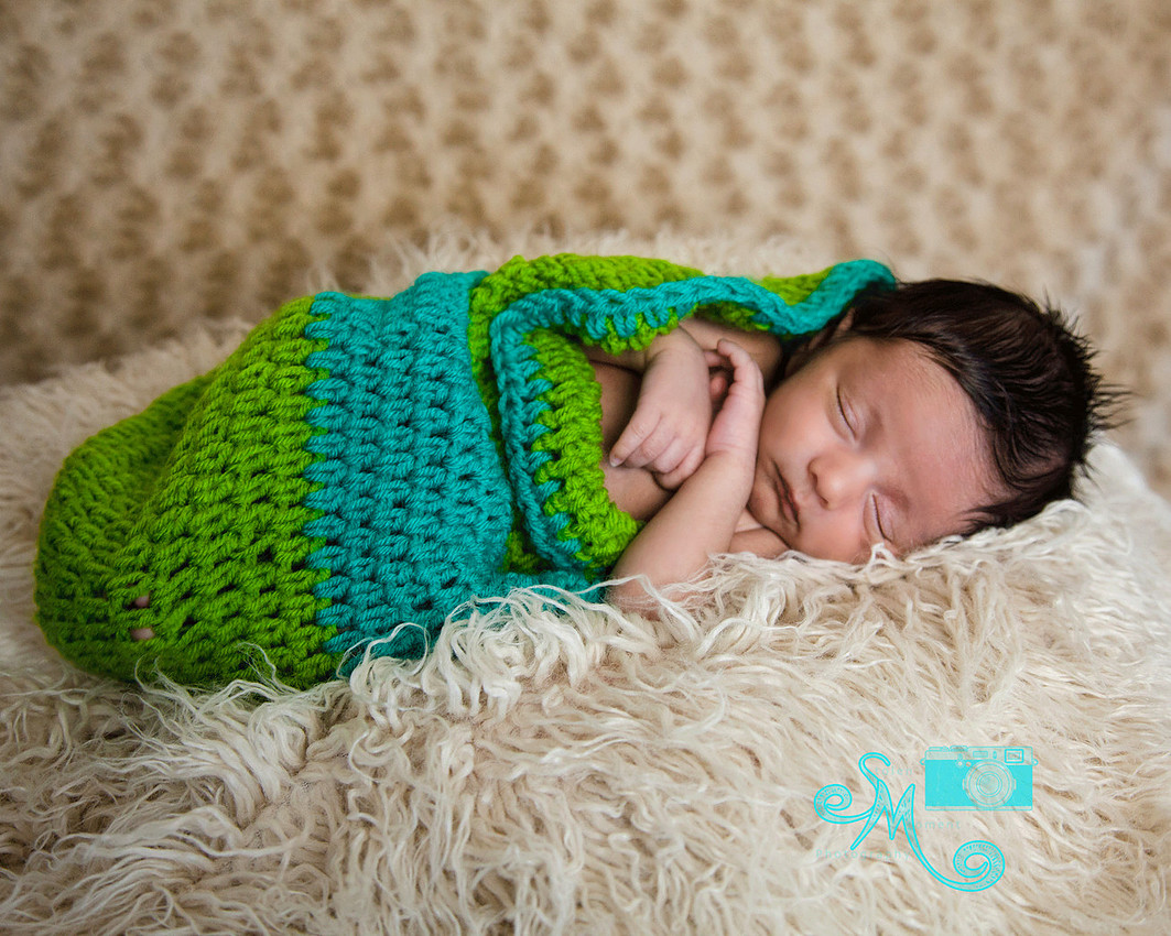 baby sleeping while in a beautiful coloured bunting bag