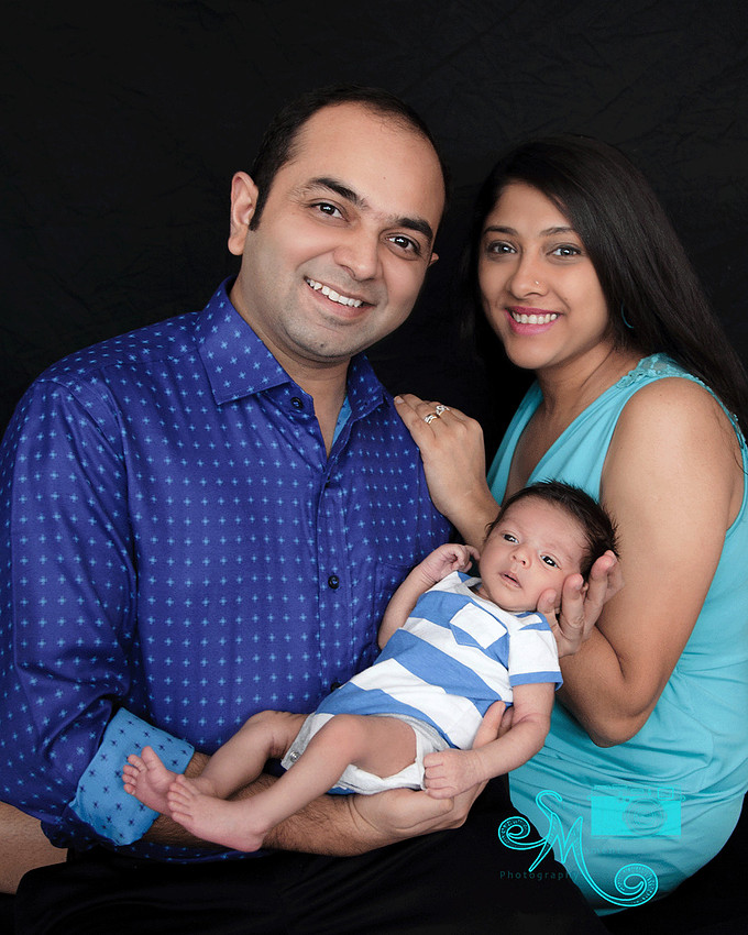 Dad holding baby boy with mom