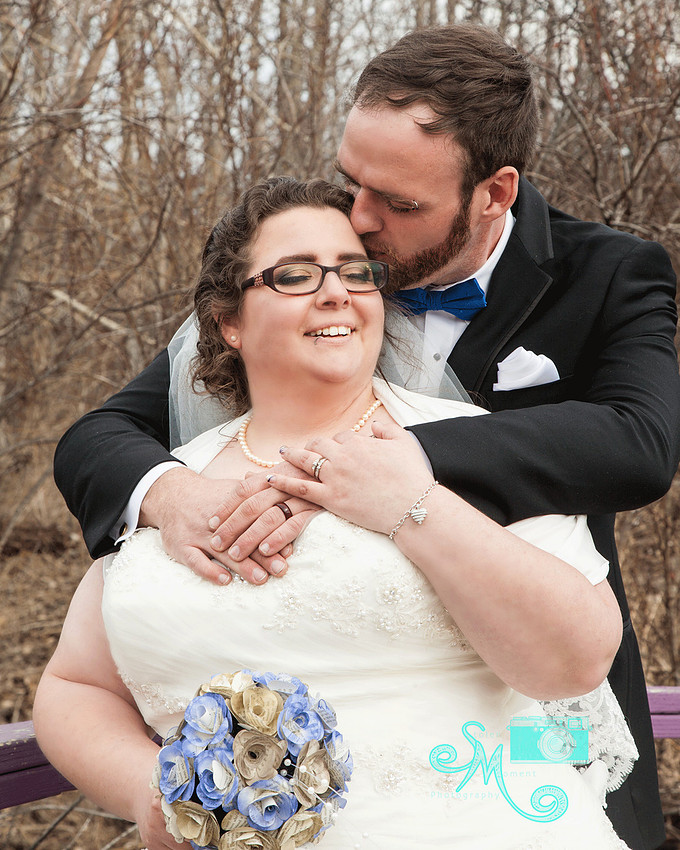 Groom kissing brides forehead