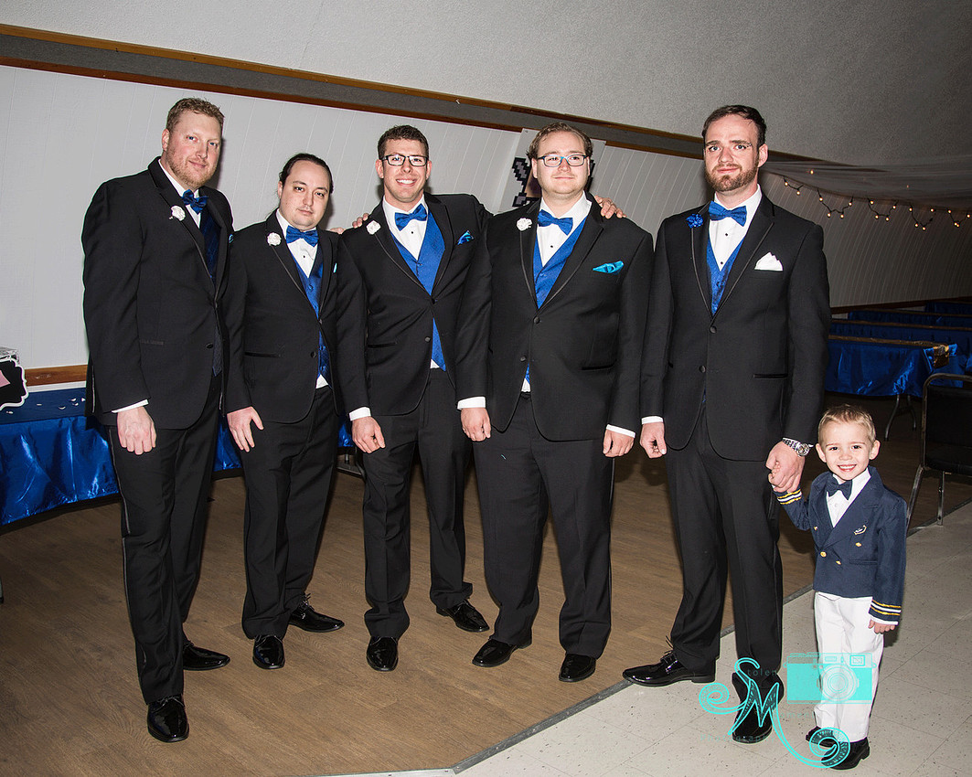 the groom and groomsmen pose for a guy shot