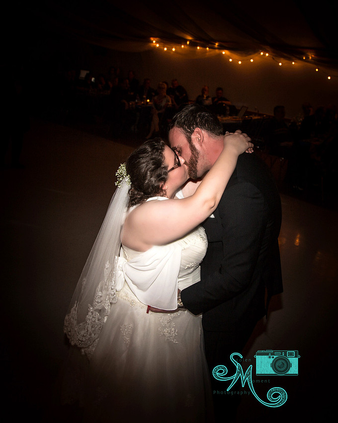 Bride and groom share a kiss during the first dance
