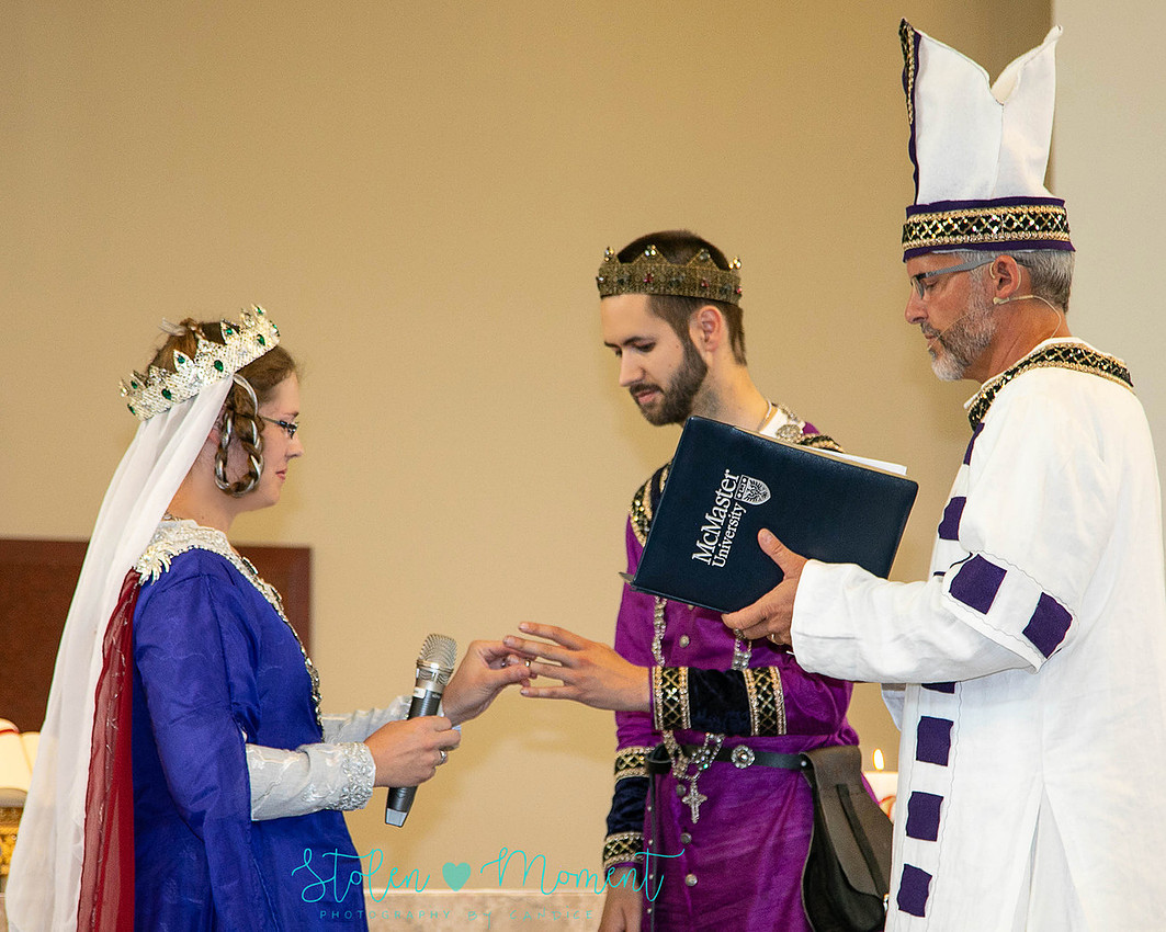 a fourteenth century bride puts the ring on the fourteenth century groom's finger