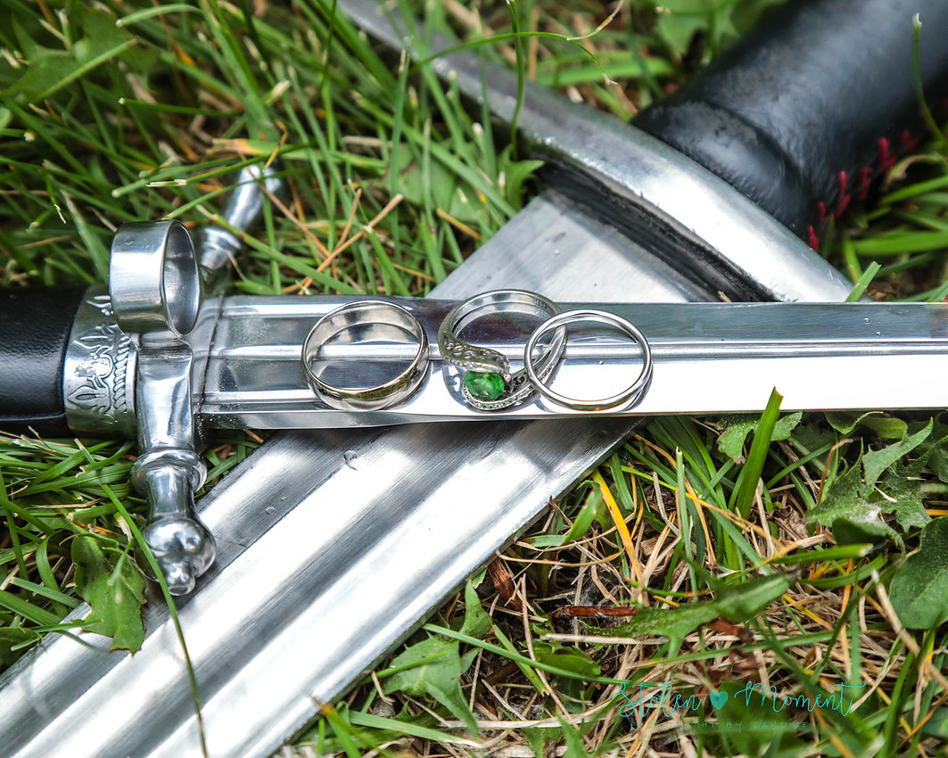 the rings of the bride and groom are placed on the groom's dagger which rests on the bride's sword