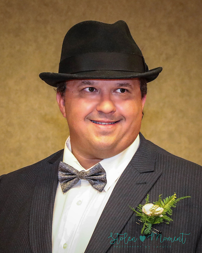 the groom sees his bride coming down the aisle and has a huge smile on his face