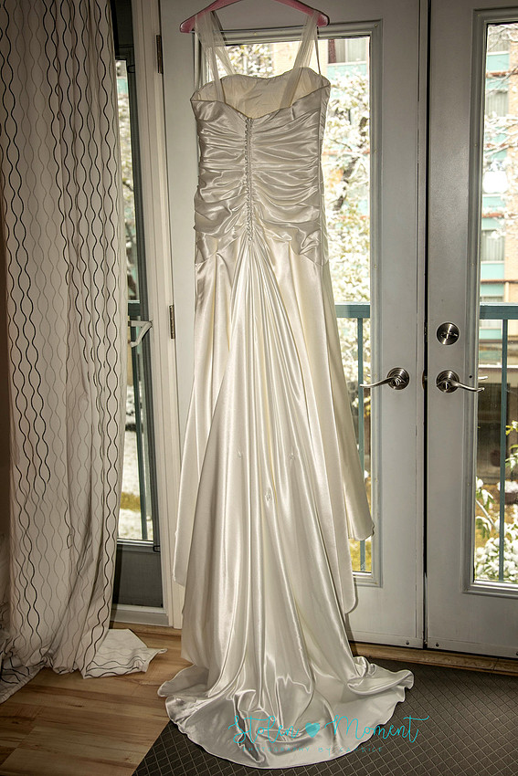 a bride in an elegant wedding dress and a groom in a white Indian suit are married at The Freemason hall in Edmonton with formals at Government House and Roger's Place on a snowy September day.