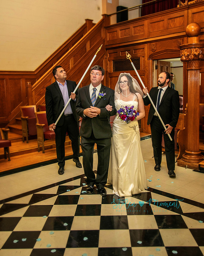 a bride in an elegant wedding dress and a groom in a white Indian suit are married at The Freemason hall in Edmonton with formals at Government House and Roger's Place on a snowy September day.