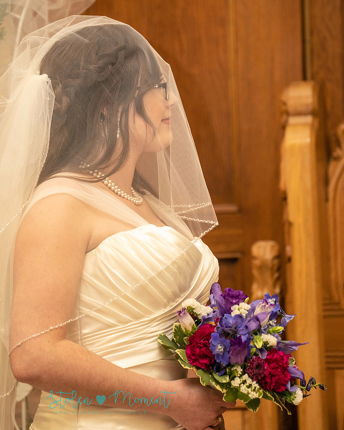 a bride in an elegant wedding dress and a groom in a white Indian suit are married at The Freemason hall in Edmonton with formals at Government House and Roger's Place on a snowy September day.