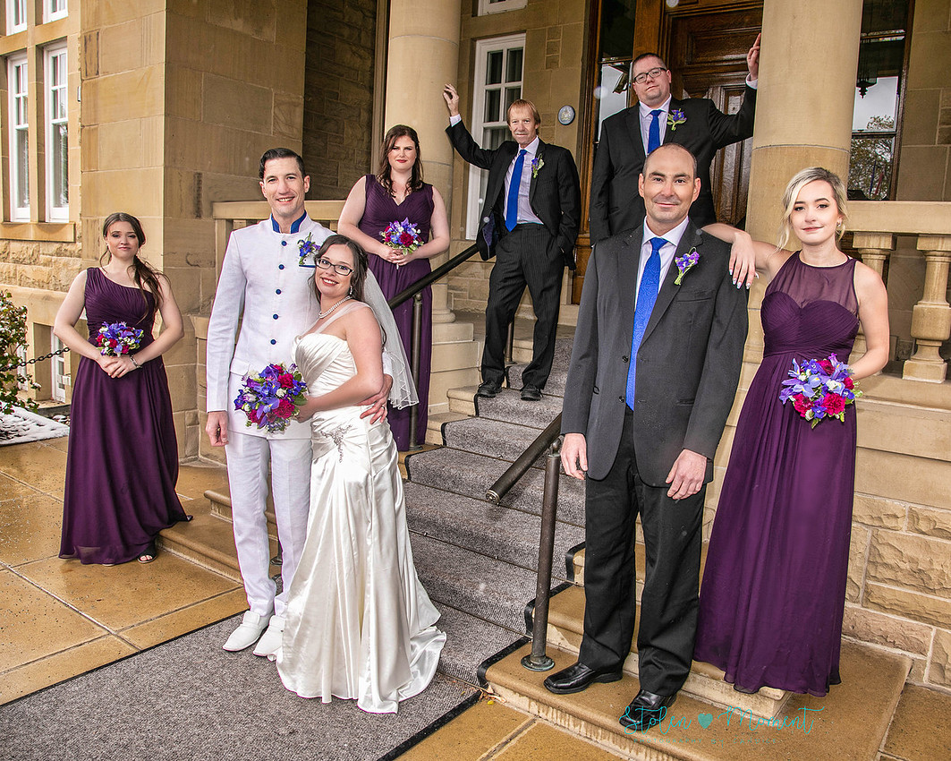 a bride in an elegant wedding dress and a groom in a white Indian suit are married at The Freemason hall in Edmonton with formals at Government House and Roger's Place on a snowy September day.