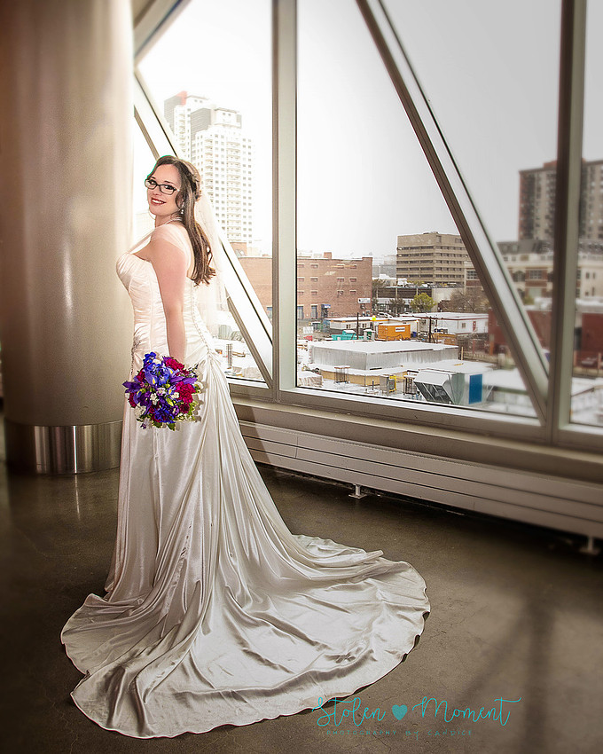 a bride in an elegant wedding dress and a groom in a white Indian suit are married at The Freemason hall in Edmonton with formals at Government House and Roger's Place on a snowy September day.