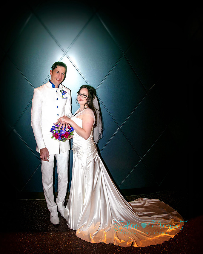 a bride in an elegant wedding dress and a groom in a white Indian suit are married at The Freemason hall in Edmonton with formals at Government House and Roger's Place on a snowy September day.