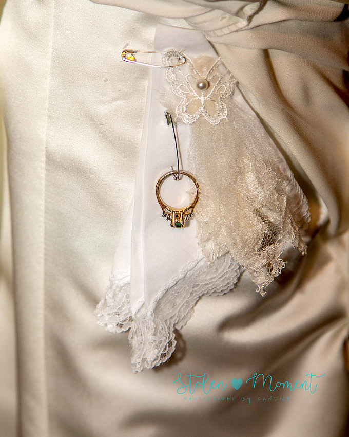 a bride in an elegant wedding dress and a groom in a white Indian suit are married at The Freemason hall in Edmonton with formals at Government House and Roger's Place on a snowy September day.