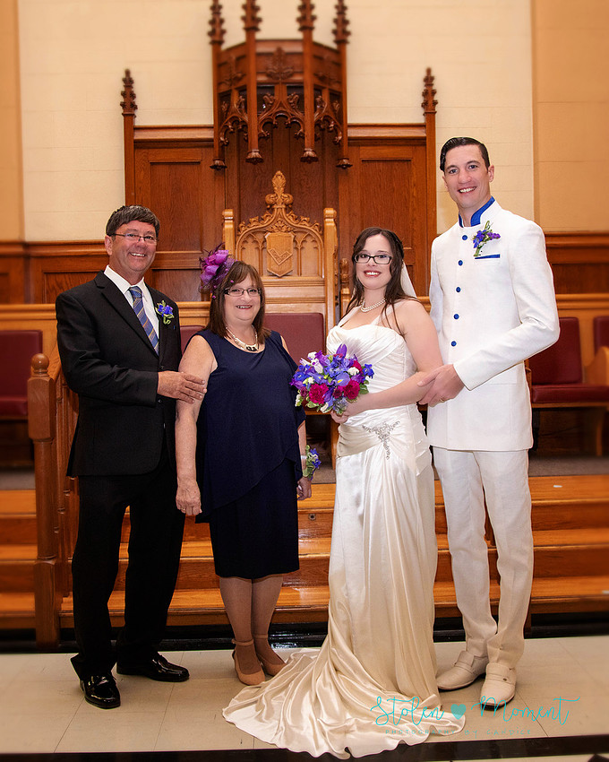 a bride in an elegant wedding dress and a groom in a white Indian suit are married at The Freemason hall in Edmonton with formals at Government House and Roger's Place on a snowy September day.
