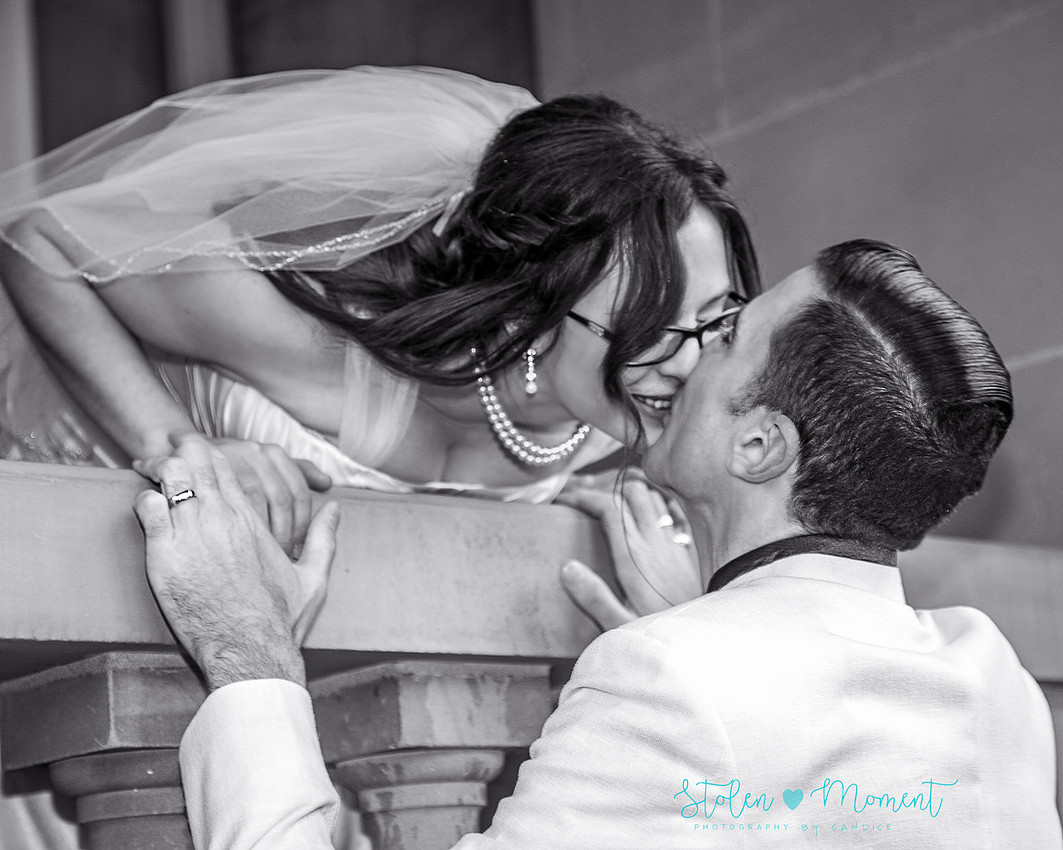 a bride in an elegant wedding dress and a groom in a white Indian suit are married at The Freemason hall in Edmonton with formals at Government House and Roger's Place on a snowy September day.