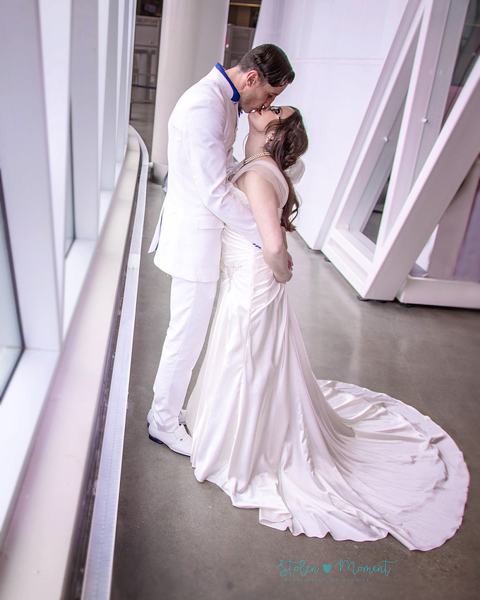 a bride in an elegant wedding dress and a groom in a white Indian suit are married at The Freemason hall in Edmonton with formals at Government House and Roger's Place on a snowy September day.