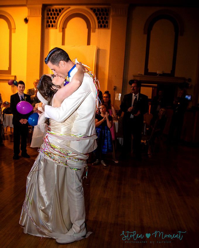 a bride in an elegant wedding dress and a groom in a white Indian suit are married at The Freemason hall in Edmonton with formals at Government House and Roger's Place on a snowy September day.