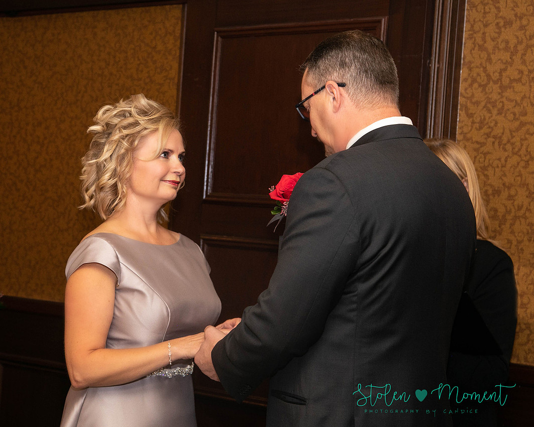 a couple are married in an elegant and intimate wedding ceremony at Ruth's Chris restaurant.