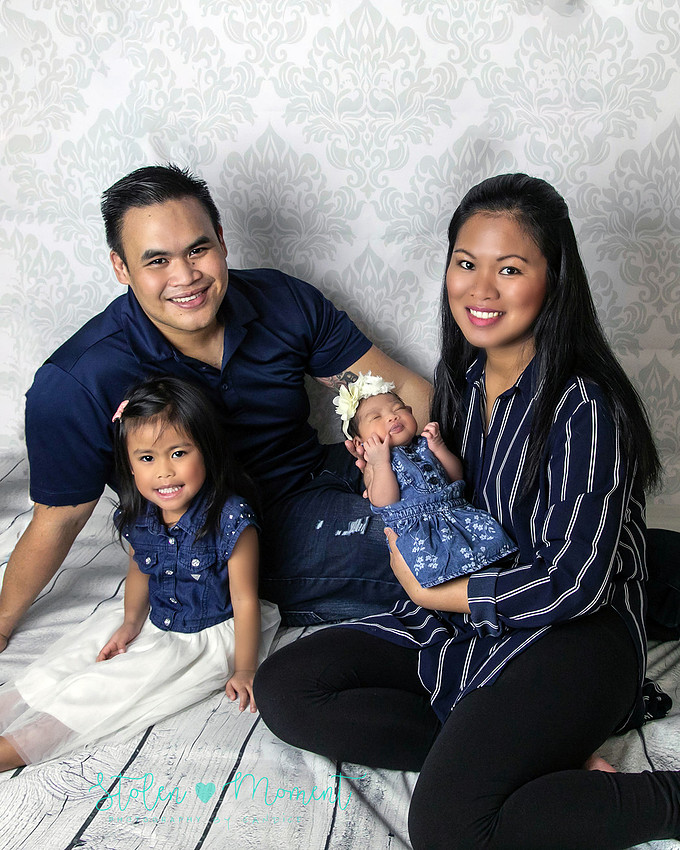a seven day old newborn girl with her big sister, mom and dad and Grandma and Grandpa
