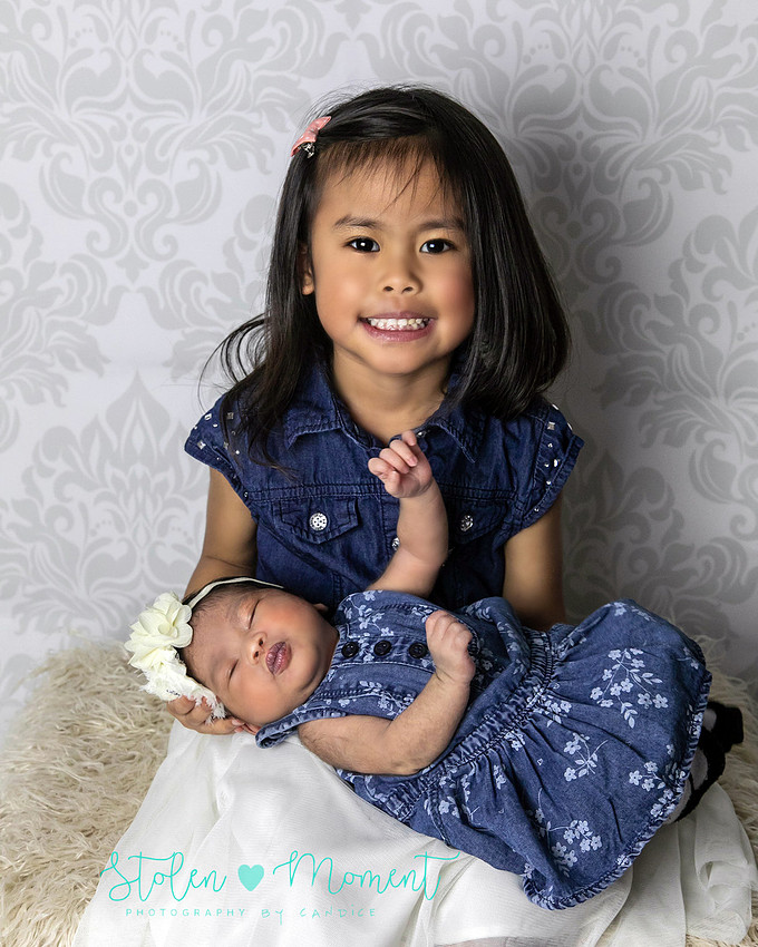 a seven day old newborn girl with her big sister, mom and dad and Grandma and Grandpa