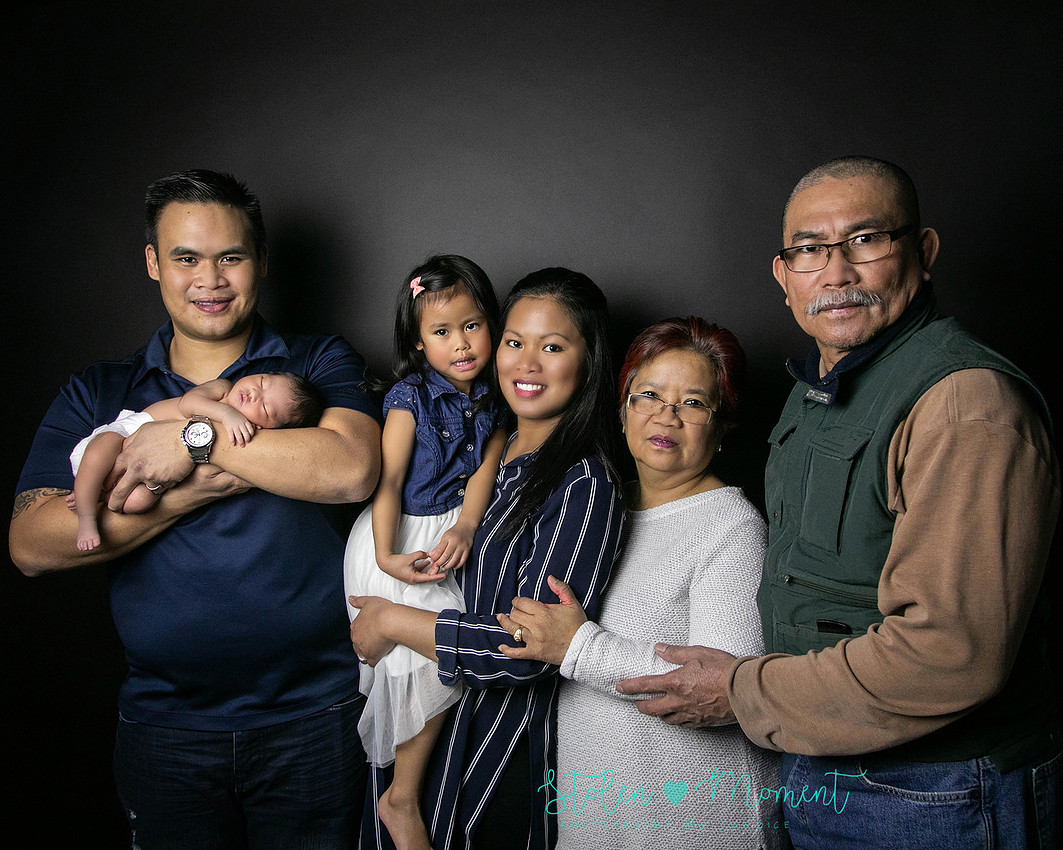 a seven day old newborn girl with her big sister, mom and dad and Grandma and Grandpa