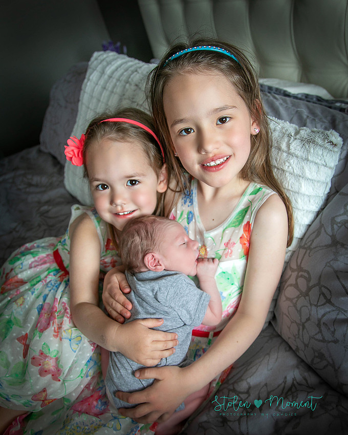 Welcoming a six day old boy in photos alone and with his two older sisters and mom and dad
